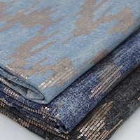 Longan Craft’s Shiny Sequin Embroidered Denim Fabric by the Yard features washed denim in light blue, denim blue, and dark gray with cotton embroidery and metallic sequins—ideal for dresses, skirts, or coats.
