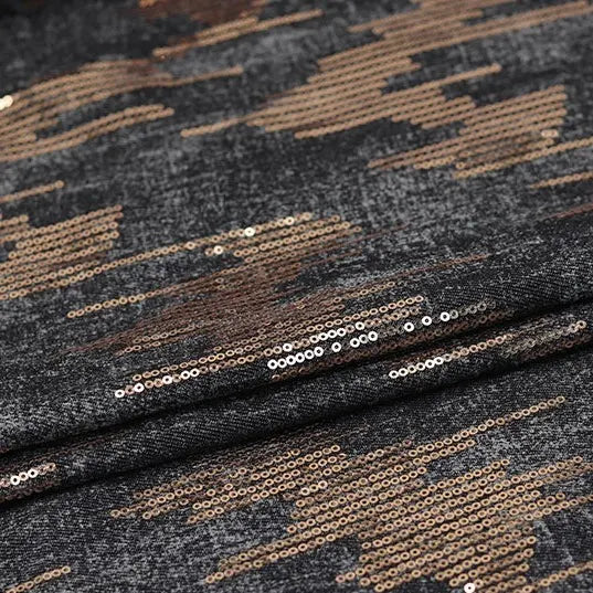 Close-up of Longan Craft's Shiny Sequin Embroidered Denim Fabric by the yard, featuring dark gray washed denim with cotton embroidery and shiny gold sequins in an abstract pattern, ideal for dresses, skirts, or coats.