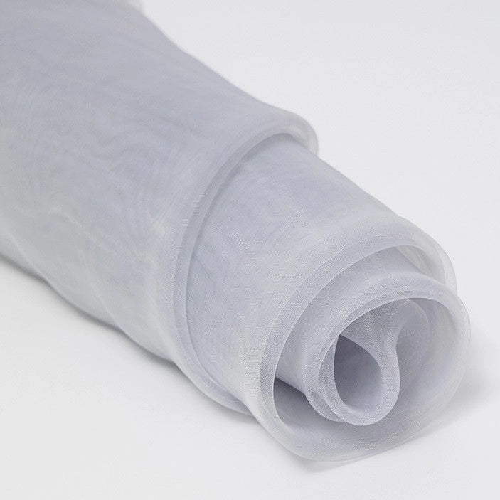 A close-up of Longan Craft’s Silky Polyester Organza Fabric By The Yard shows its soft, sheer, glossy texture in white—ideal for bridal and evening wear. Premium solid color material with elegant folds is perfect for dresses and decorations.
