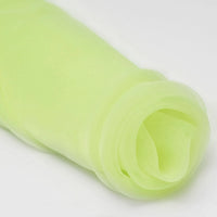 A close-up of Longan Craft's Silky Polyester Organza Fabric By The Yard shows the premium, soft, and sheer bridal organza material in light green—ideal for gowns and dresses, with delicate folds and a smooth, translucent texture.
