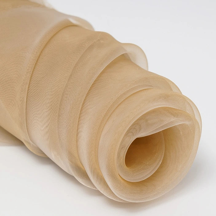 A close-up of Longan Craft’s Silky Polyester Organza Fabric By The Yard shows soft, sheer, premium beige material with delicate, wavy folds—ideal for bridal gowns or evening dresses. This solid color fabric is lightweight and perfect for elegant projects.