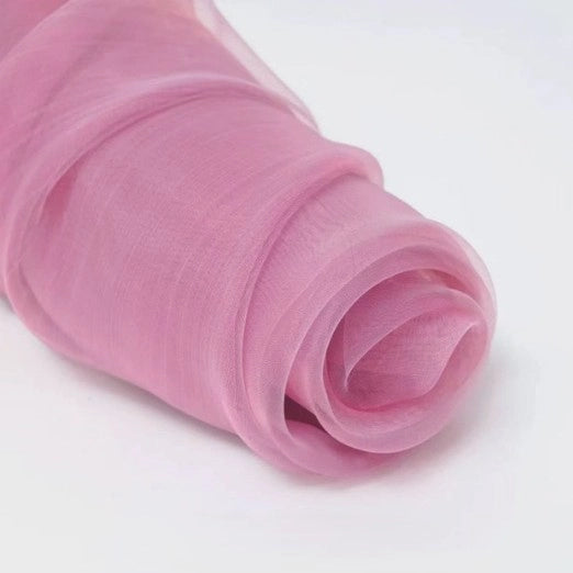 A close-up of Longan Craft’s Silky Polyester Organza Fabric by the yard in light pink, a premium, soft and sheer solid organza—ideal for bridal gowns or evening dresses—displayed on a white background.