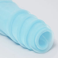 Longan Craft’s Silky Polyester Organza Fabric By The Yard is a premium solid color, soft and sheer material—ideal for bridal gowns or evening dresses. Shown here in light blue, partially unrolled in soft layers on a white surface.