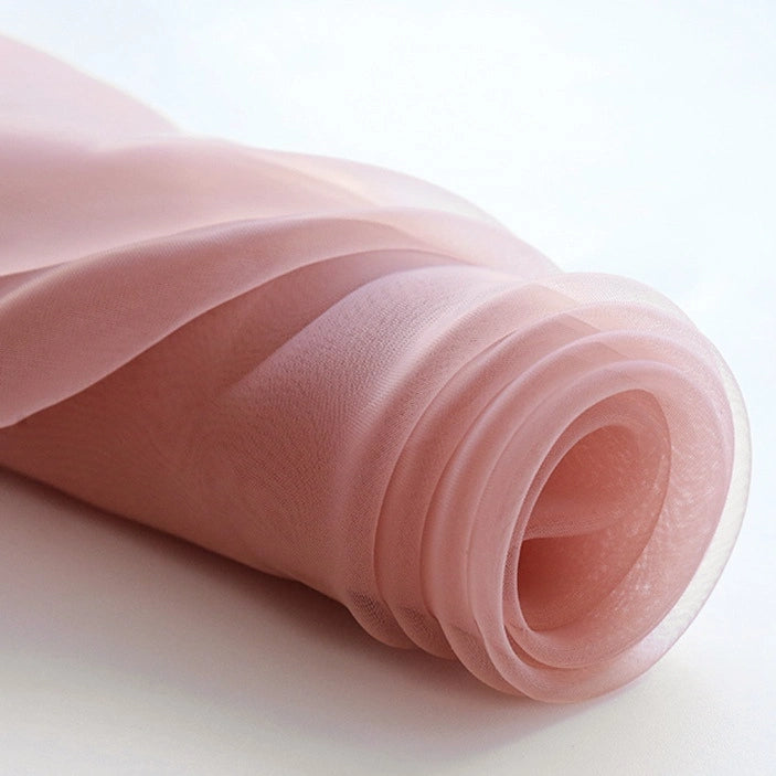 A close-up of Longan Craft's Silky Polyester Organza Fabric By The Yard shows its soft, sheer texture—this premium solid color organza material is perfect for elegant evening dress or bridal gown projects.