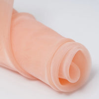 A close-up of Longan Craft’s Silky Polyester Organza Fabric by the yard in peach—premium, soft, and sheer bridal organza material, perfect for crafting elegant gowns or evening dresses.