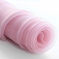 A close-up of Longan Craft’s Silky Polyester Organza Fabric By The Yard, a premium solid color organza in light pink. This soft, sheer bridal material is perfect for layered curves in gowns and evening dresses.