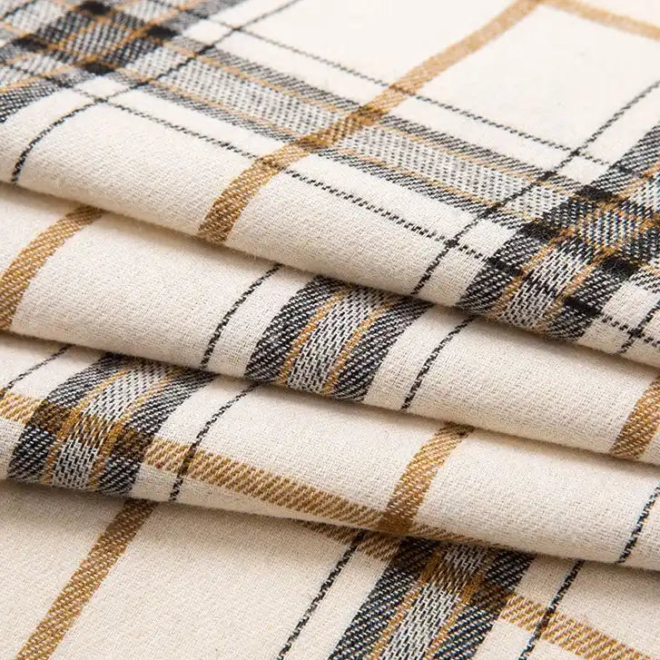 Here’s a rewritten sentence using your product data: Close-up of folded Single Sided Sueded Plaid Flannel Fabric By The Yard from Longan Craft, featuring a cream base with black and light brown plaid lines. This medium weight, premium soft polyester cotton flannel displays a classic pattern and smooth texture—ideal for flannel clothing or craft projects.