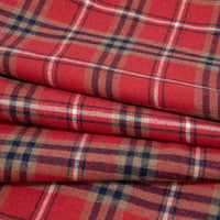 A close-up of the Single Sided Sueded Plaid Flannel Fabric By The Yard from Longan Craft showcases its red plaid design with intersecting lines of navy blue, white, and tan, neatly folded in layers. The soft texture and brushed finish highlight the premium quality of this medium weight polyester cotton flannel textile—ideal for clothing and crafts.