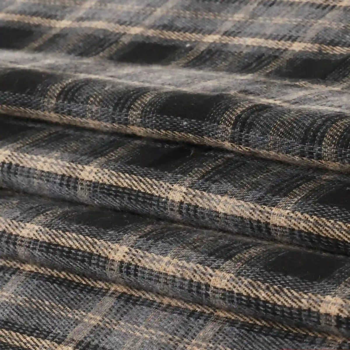 Neatly layered, folded fabric displays a black, beige, and gray plaid pattern with intersecting lines. This Single Sided Sueded Plaid Flannel Fabric By The Yard from Longan Craft features premium medium weight polyester cotton material and a brushed finish for exceptional softness and warmth—an ideal choice for any flannel project.
