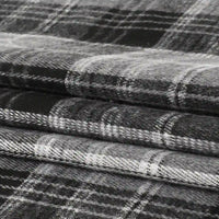 Neatly stacked in three layers, the Longan Craft Single Sided Sueded Plaid Flannel Fabric By The Yard features a classic black, white, and gray checkered pattern. This premium soft medium-weight polyester cotton flannel textile boasts a sueded finish for a cozy texture—perfect for clothing and craft projects.