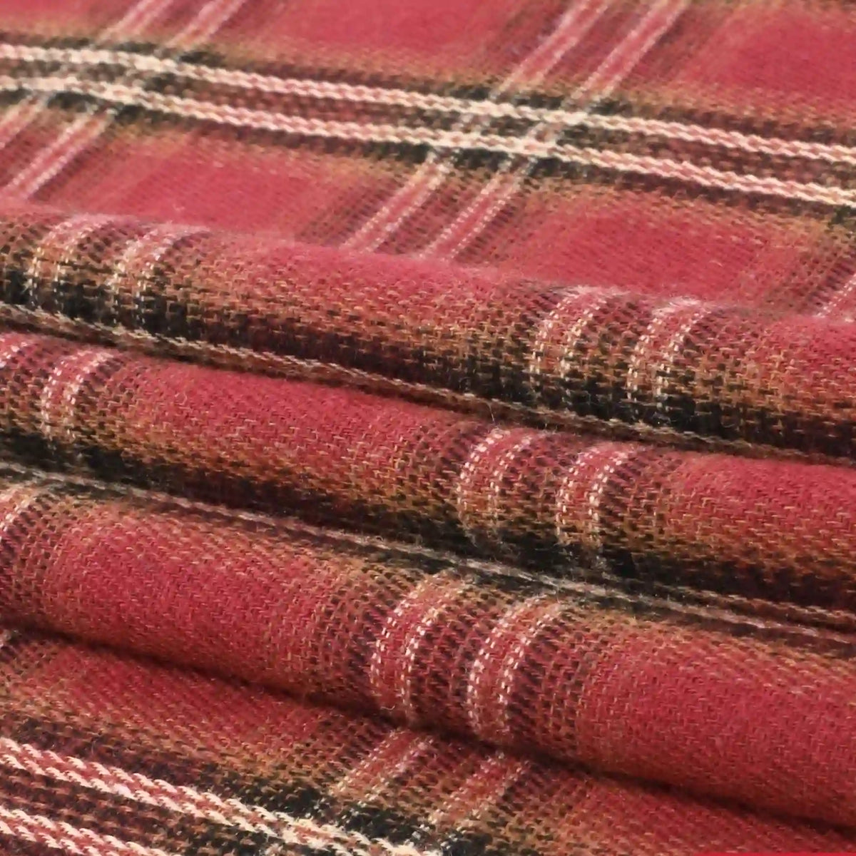 A close-up of the Single Sided Sueded Plaid Flannel Fabric By The Yard from Longan Craft showcases its red, black, white, and tan checkered pattern. The premium medium weight polyester cotton blend highlights the brushed texture and visible weave of this soft flannel clothing material.