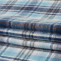 Soft, single-sided sueded plaid flannel fabric in blue, white, and brown from Longan Craft features a checkered design with horizontal and vertical lines—ideal for your next project requiring premium medium weight polyester cotton flannel by the yard.