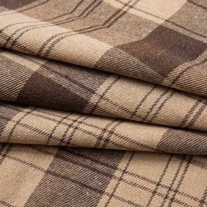 Experience the premium softness of Longan Craft’s Single Sided Sueded Plaid Flannel Fabric By The Yard—a medium weight polyester cotton textile in brown and beige plaid, featuring intersecting lines and varied squares for a textured, layered look that’s perfect for cozy clothing and crafting projects.