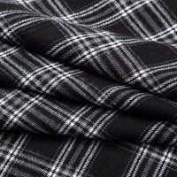 Close-up of Longan Craft’s Single Sided Sueded Plaid Flannel Fabric By The Yard, a medium weight polyester cotton textile in black with a white plaid pattern; the diagonal folds showcase the fabric’s soft sueded finish and emphasize the intersecting lines for added texture.