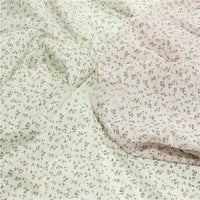 Longan Craft’s Small Floral Printed Voile Fabric By The Yard features 100% cotton with a soft cream base, delicate pink flowers, and green leaves—perfect for summer clothing. Material is lightweight and drapes beautifully.