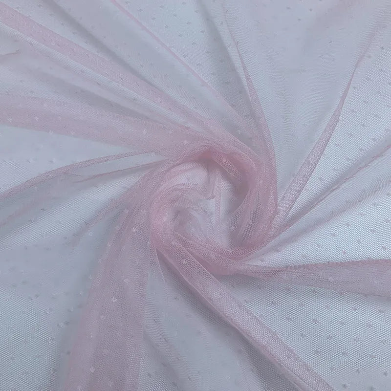 A close-up of Longan Craft's Small Polka Dot Tulle Fabric By The Yard, a colorful and soft polyester tulle with delicate dots—ideal for veils, dresses, or elegant wedding attire.