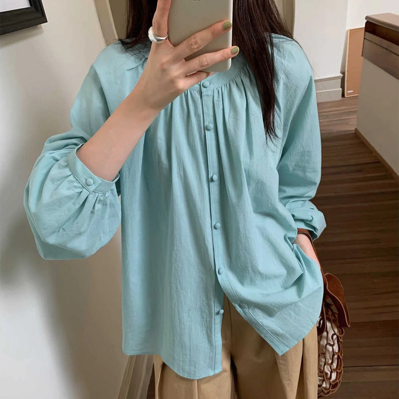 Person wearing the Smocked Crewneck Raglan Sleeve Blouse from Longan Craft—download this free PDF sewing pattern for your next DIY project!.