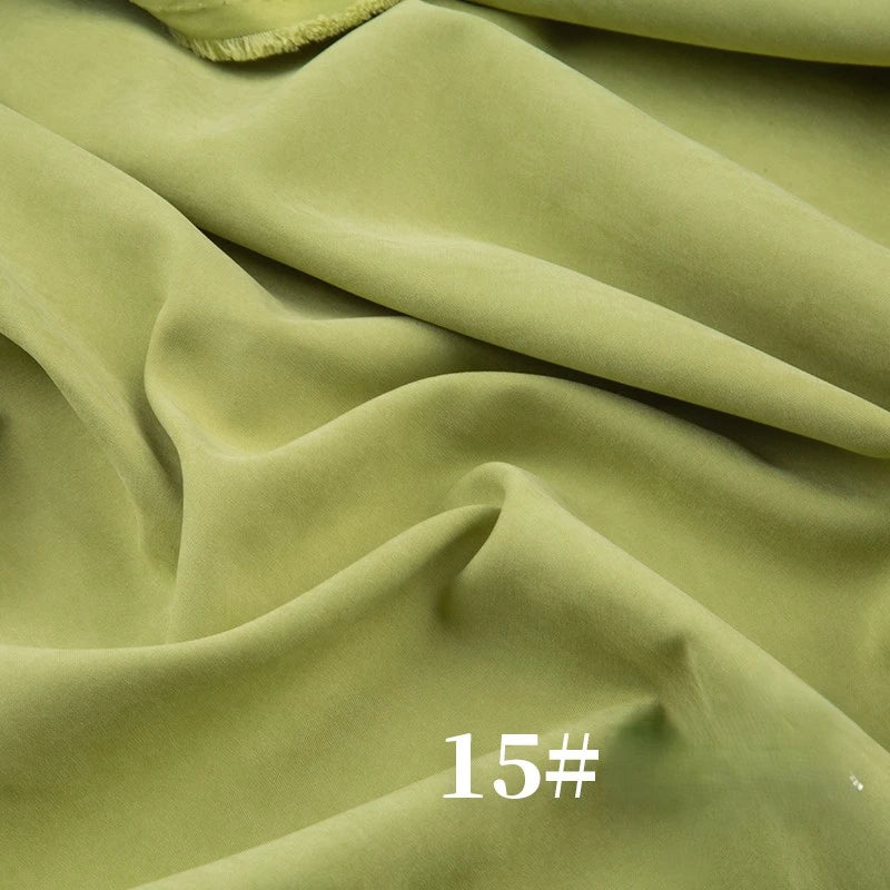 Longan Craft Solid Color Brushed Polyester Peachskin Fabric by the yard features a soft, velvety texture in light green with gentle drape. The white 15# mark at the bottom right makes it ideal for dressmaking and crafts.