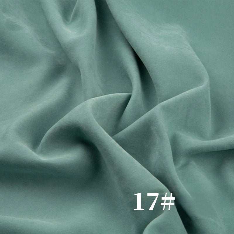Longan Craft’s Solid Color Brushed Polyester Peachskin Fabric features a soft, velvety microsuede texture in light green—perfect for dressmaking. The number 17# is shown in white at the bottom right corner.