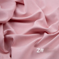 Longan Craft's Solid Color Brushed Polyester Peachskin Fabric By The Yard features a soft pink, velvety texture draped in gentle folds. White "2#" text appears at the bottom right. Ideal midweight microsuede for dressmaking and crafts.