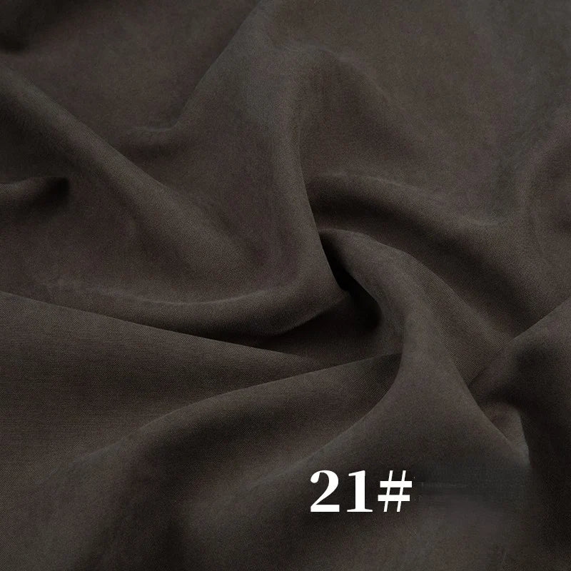 Longan Craft’s Solid Color Brushed Polyester Peachskin Fabric by the yard features soft, velvety midweight microsuede—ideal for dresses. The photo shows dark brown fabric with gentle folds and “21#” in white text at the bottom.