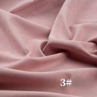 Soft, light pink Longan Craft Solid Color Brushed Polyester Peachskin Fabric with gentle folds, featuring a velvety microsuede texture, and white "3#" text in the lower right corner. Ideal for dressmaking.