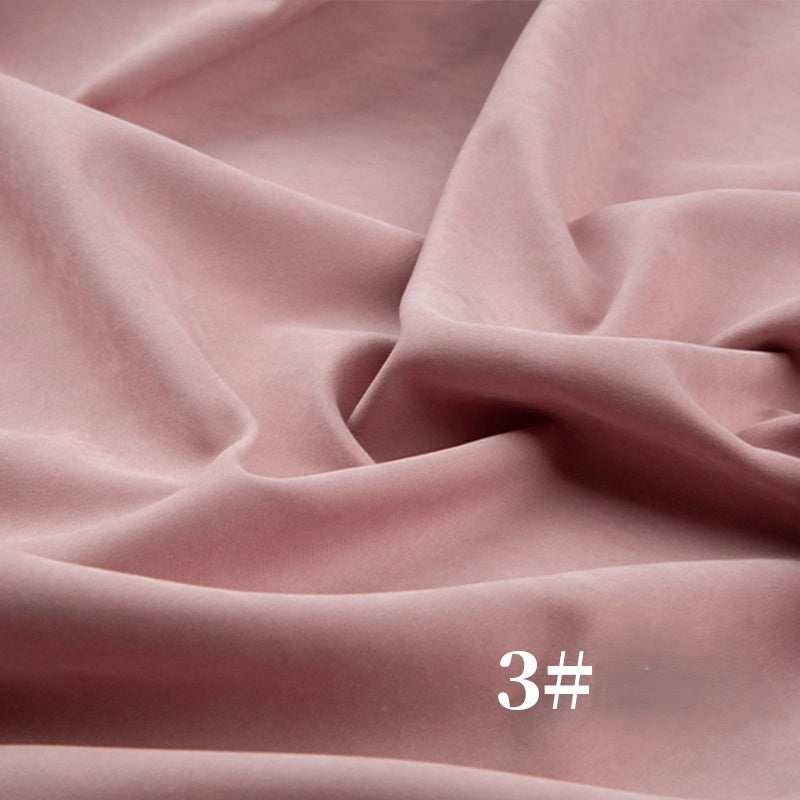 Soft, light pink Longan Craft Solid Color Brushed Polyester Peachskin Fabric with gentle folds, featuring a velvety microsuede texture, and white "3#" text in the lower right corner. Ideal for dressmaking.