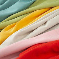 Longan Craft's Solid Color Brushed Polyester Peachskin Fabric features neatly layered pastel and bright shades—blue, green, yellow, white, pink, and red—perfect midweight microsuede for dressmaking with a velvety peachskin texture.