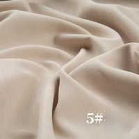 A close-up of Longan Craft’s Solid Color Brushed Polyester Peachskin Fabric By The Yard, midweight microsuede with a velvety texture, in light beige. "5#" appears in white text at the lower right. Ideal for dressmaking.
