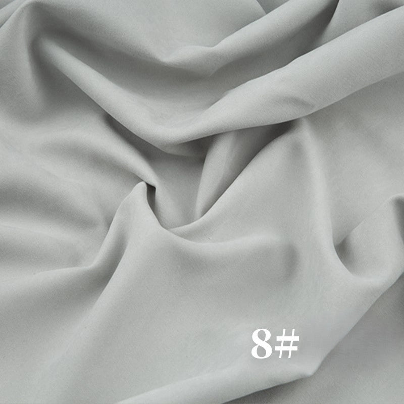 The Longan Craft Solid Color Brushed Polyester Peachskin Fabric By The Yard features a soft, velvety microsuede texture in light grey with #8 printed in white, making it ideal for dressmaking and perfect for smooth, gently draped garments.