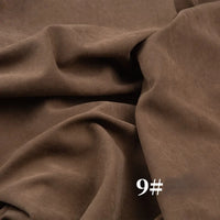 Close-up of Longan Craft Solid Color Brushed Polyester Peachskin Fabric by the yard, midweight microsuede with a smooth, velvety texture in brown. The fabric is draped in soft folds and features the number 9# printed in white at the bottom right.