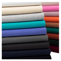 A stack of Longan Craft Solid Color Cotton French Terry Fabric by the yard, featuring cream, pink, red, orange, teal, blue, purple, gray, and black shades, is arranged in a beautiful gradient from light to dark—perfect for hoodies.