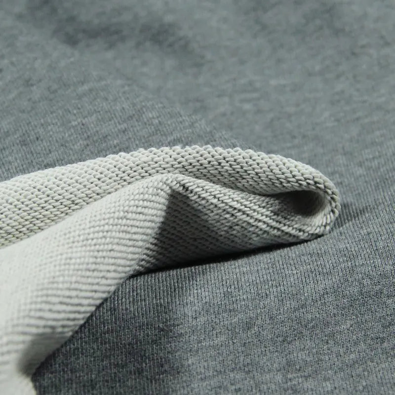 Close-up of Longan Craft’s Solid Color Cotton French Terry Fabric By The Yard, showing the smooth outer side and textured inner side with a visible seam—an ideal, thick French terry material for hoodies.