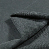 Close-up of Longan Craft Solid Color Cotton French Terry Fabric by the yard in dark gray, folded to show its smooth front and textured back—perfect thick material for hoodies and sweatshirts.