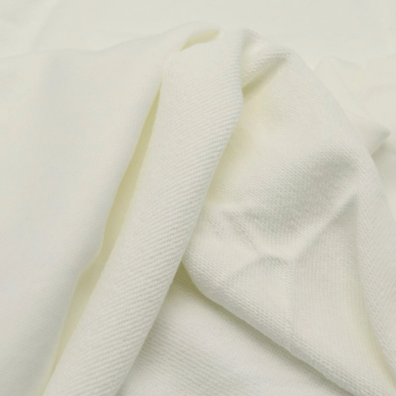 A close-up of Longan Craft’s Solid Color Cotton French Terry Fabric By The Yard shows its thick, smooth texture and subtle diagonal lines—ideal for hoodies and other cozy projects.