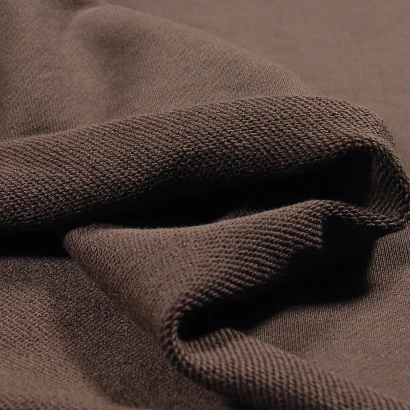 Close-up of brown Solid Color Cotton French Terry Fabric by Longan Craft shows its thick, ribbed weave and soft edges—highlighting the cozy texture ideal for hoodies.