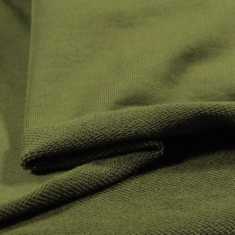 Close-up of Longan Craft’s Solid Color Cotton French Terry Fabric By The Yard in olive green, neatly folded to show its thick, soft, and textured surface—ideal French terry fabric for hoodies and other cozy projects.