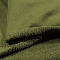 Close-up of Longan Craft’s Solid Color Cotton French Terry Fabric By The Yard in olive green, neatly folded to show its thick, soft, and textured surface—ideal French terry fabric for hoodies and other cozy projects.