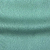 Close-up of Longan Craft’s Solid Color Denim Lyocell Fabric By The Yard, featuring a soft diagonal weave in light teal. This wrinkle-free, breathable material is perfect for comfy jeans and other projects.