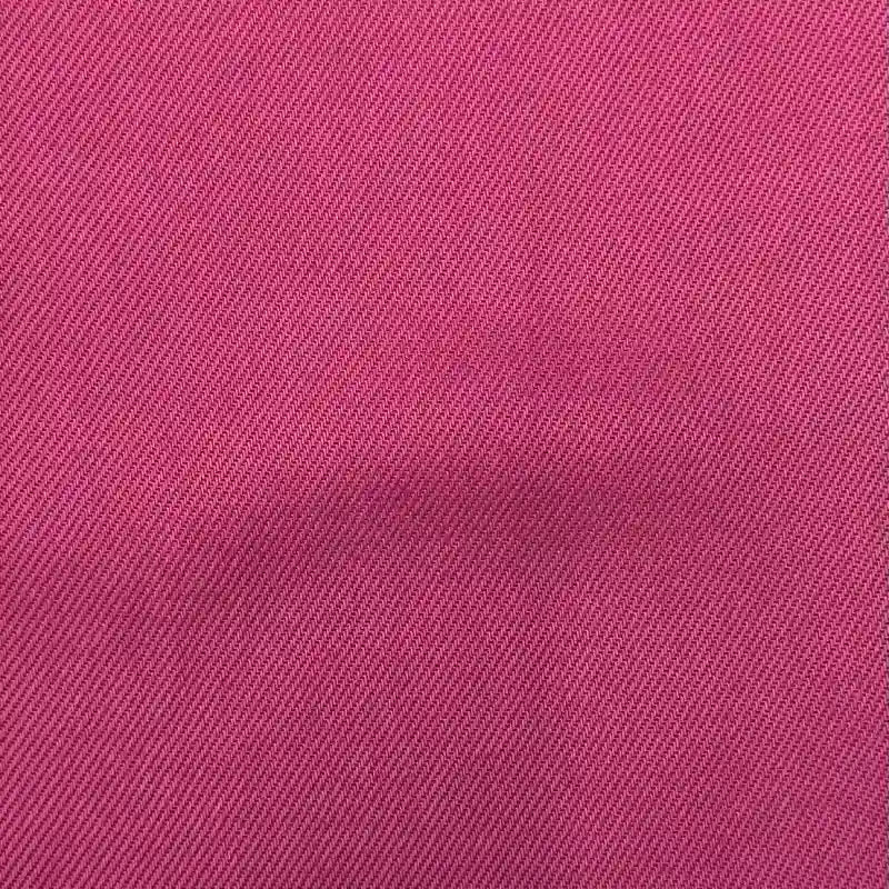 Close-up of Longan Craft's Solid Color Denim Lyocell Fabric by the yard—wrinkle-free, breathable, and comfy material with a pink dye and diagonal weave, ideal for sustainable jeans and fashion projects.