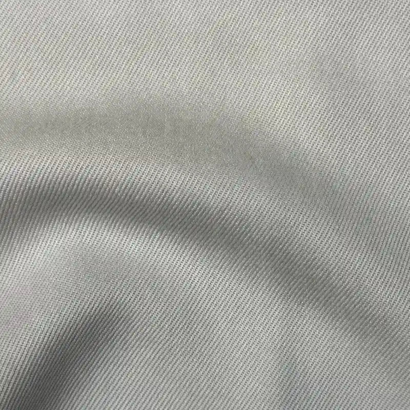 Close-up of Longan Craft’s Solid Color Denim Lyocell Fabric By The Yard, showing its light gray shade, diagonal twill weave, wrinkle-free texture, and soft folds for a breathable, comfy jean material.