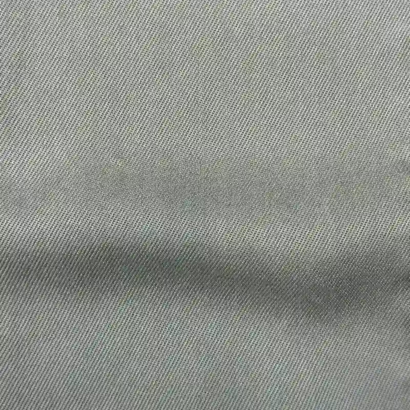 Close-up of Longan Craft’s Solid Color Denim Lyocell Fabric By The Yard—a light gray, wrinkle-free, breathable textile with a diagonal twill weave, ideal for comfy jeans and sustainable fashion projects.