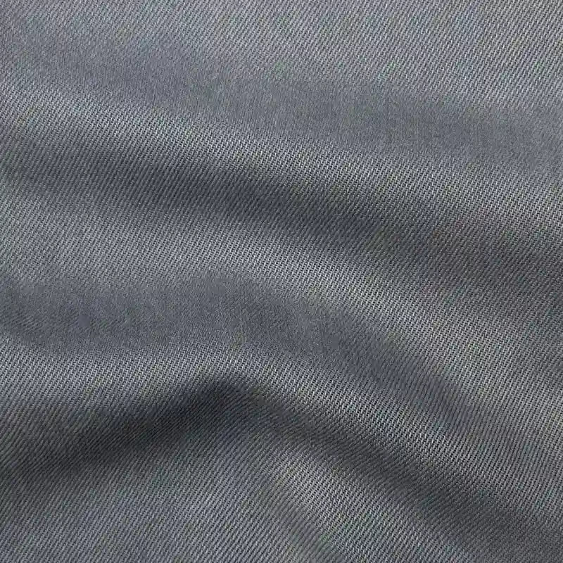 Close-up of Longan Craft's Solid Color Denim Lyocell Fabric by the yard, featuring a wrinkle-free, breathable material with a subtle diagonal weave—perfect for comfy and sustainable jeans or fashion projects.