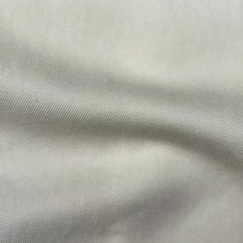 Close-up of Longan Craft’s Solid Color Denim Lyocell Fabric by the yard—breathable, comfy, wrinkle-free denim with a smooth finish and subtle diagonal texture, ideal for sustainable jeans and fashion projects.