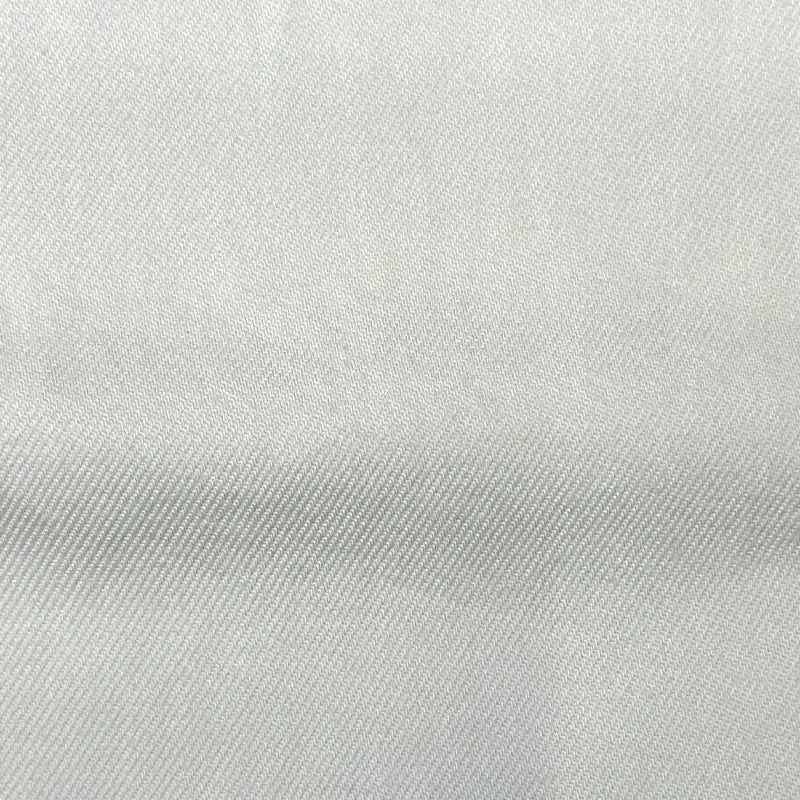 Close-up of Longan Craft’s Solid Color Denim Lyocell Fabric—breathable, wrinkle-free, and smooth with a diagonal twill weave. This comfy, off-white material by the yard is ideal for sustainable jeans and fashion projects.