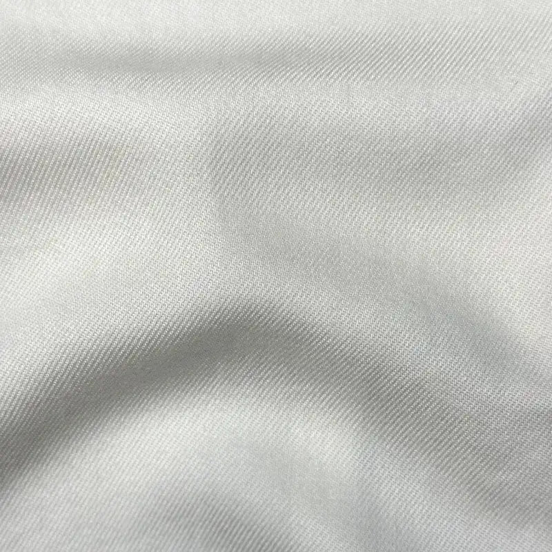 Close-up of Longan Craft’s Solid Color Denim Lyocell Fabric by the yard, featuring a smooth, wrinkle-free texture and subtle diagonal weave—breathable and comfy for sustainable jeans and fashion.