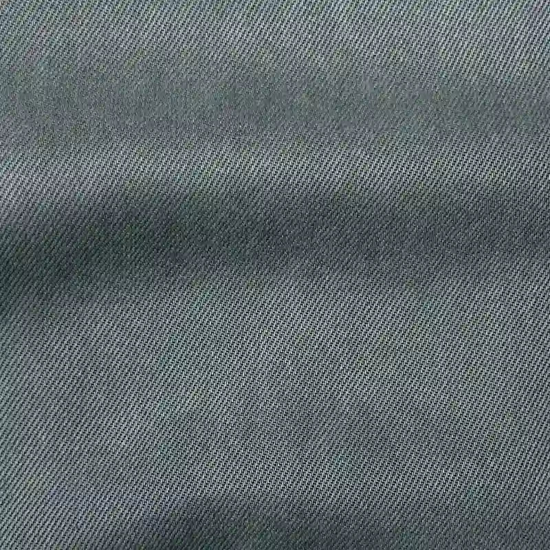 Close-up of Longan Craft’s Solid Color Denim Lyocell Fabric By The Yard shows its diagonal twill weave, subtle texture, and color variation—this wrinkle-free, breathable material is ideal for comfy, sustainable jeans or fashion projects.