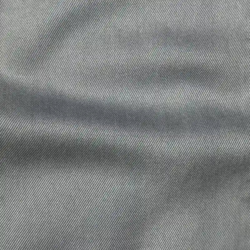 Close-up of Longan Craft’s Solid Color Denim Lyocell Fabric by the Yard—wrinkle-free, breathable, and comfy material with fine diagonal weave, ideal for sustainable jeans and fashion projects.