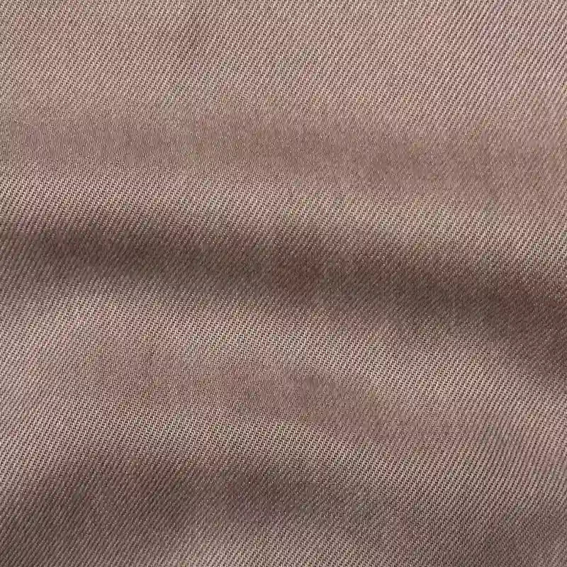 Close-up of Solid Color Denim Lyocell Fabric By The Yard from Longan Craft—wrinkle-free, breathable, and comfy textile with a diagonal twill weave and soft folds, perfect for sustainable jeans and fashion projects.