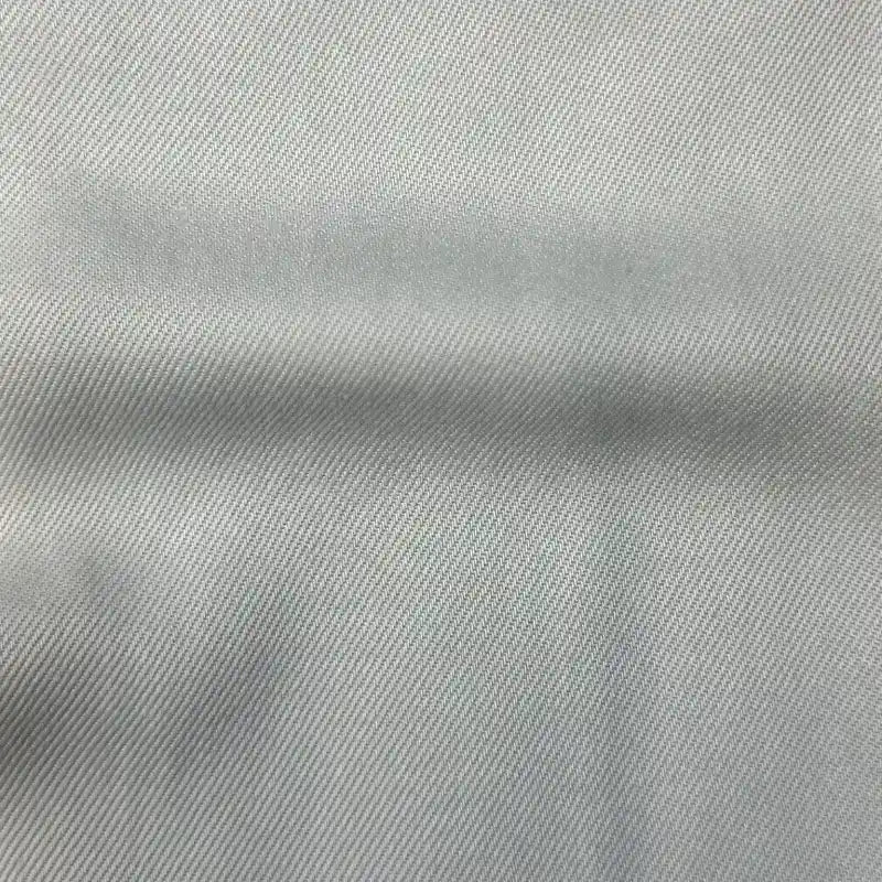 Close-up of Longan Craft Solid Color Denim Lyocell Fabric by the yard—a wrinkle-free, breathable, and comfy lyocell textile with a subtle diagonal twill pattern, ideal for sustainable fashion and perfect for making jeans.